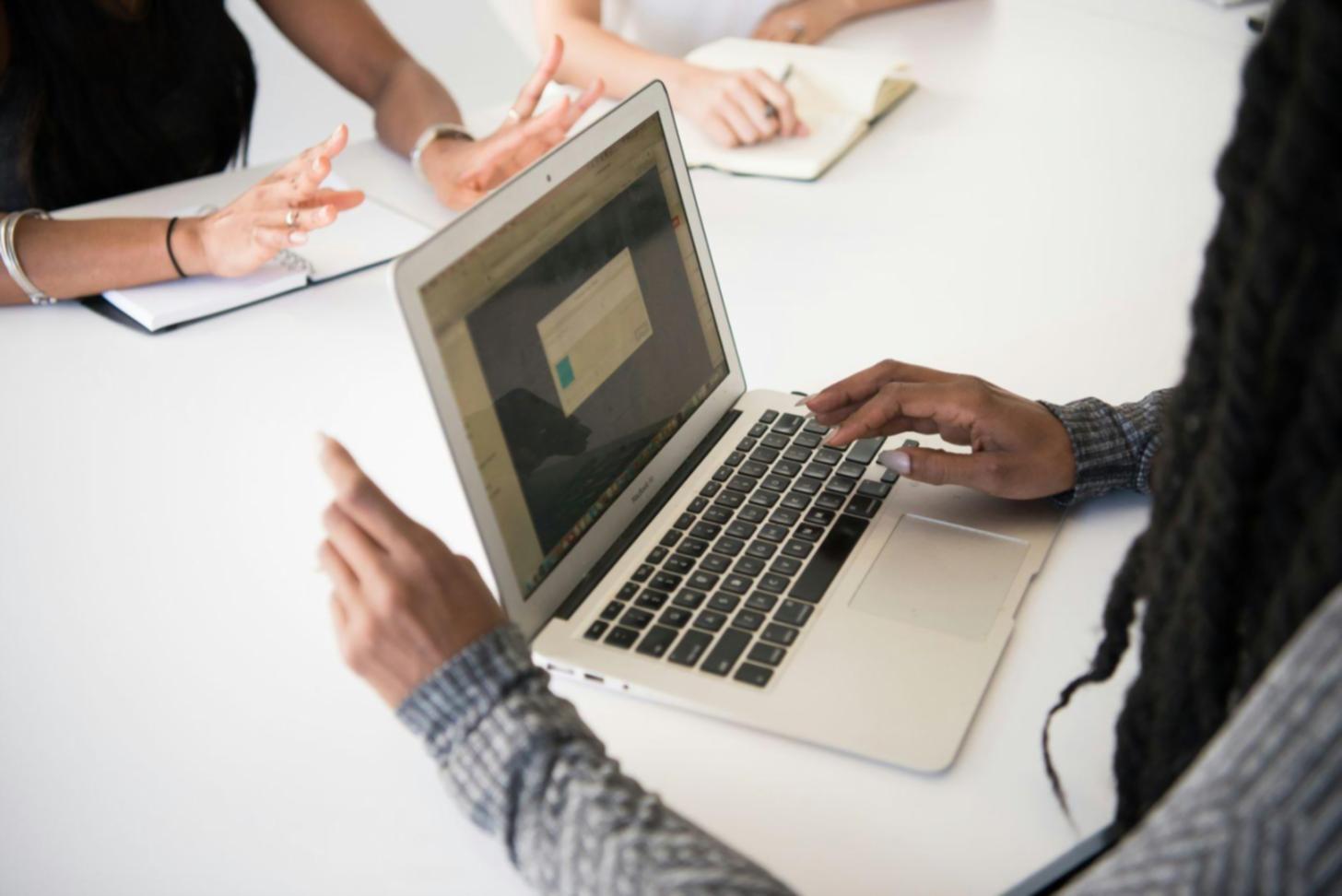 Financial analysis training session with business professionals reviewing real-world data and collaborative problem-solving